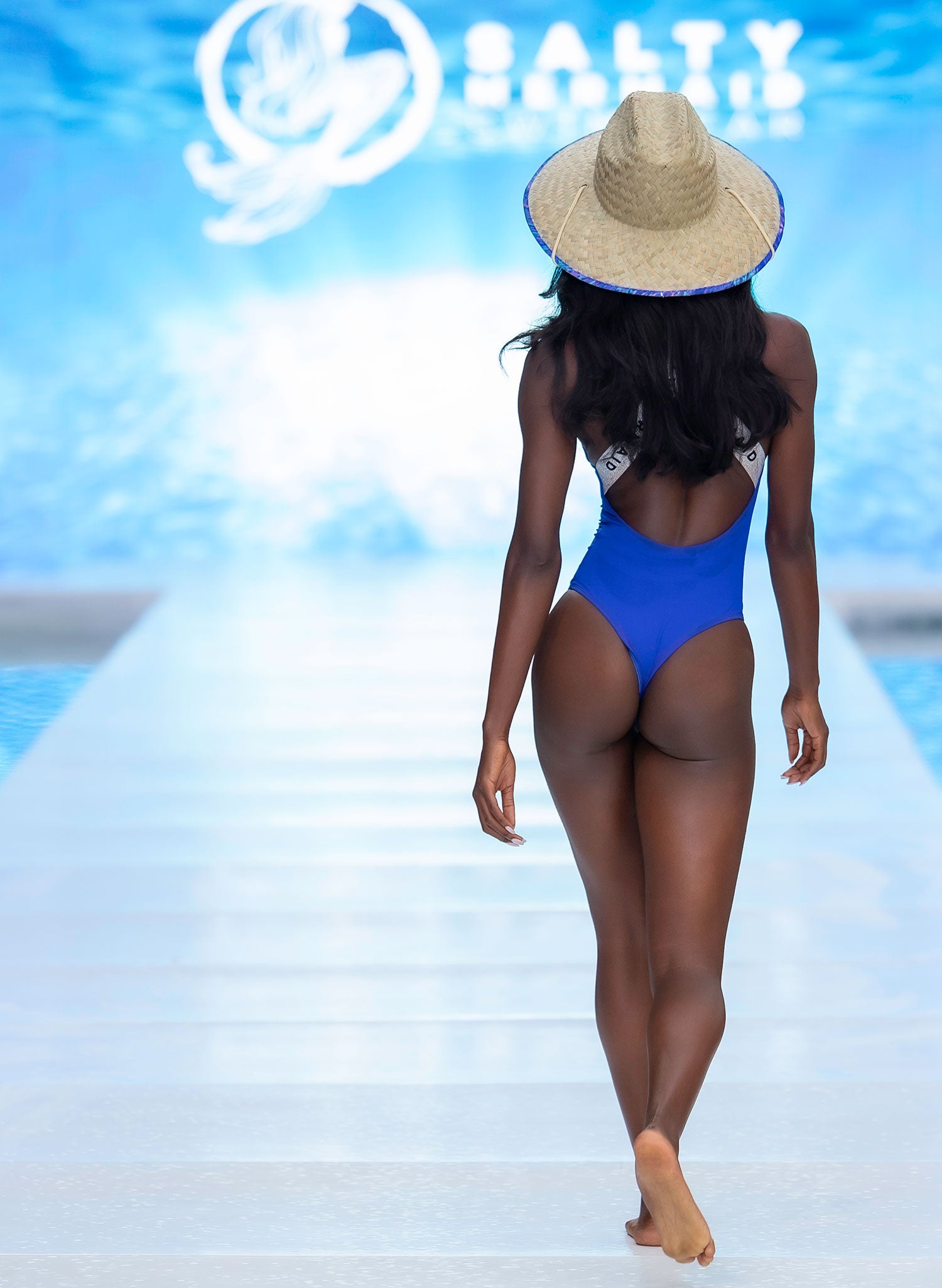 Runway shot of Salty Mermaid athletic band swimsuit in blue — sporty banded one piece with supportive straps and sleek fit.
