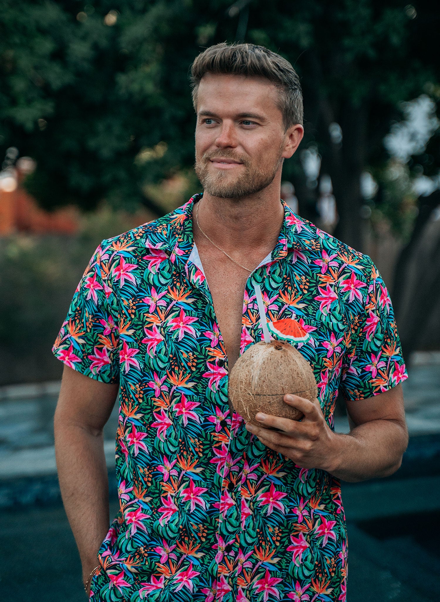 Salty Mermaid men’s collared button shirt in Island Bloom, hand-drawn floral print, in bold orange green and pink tropical print.