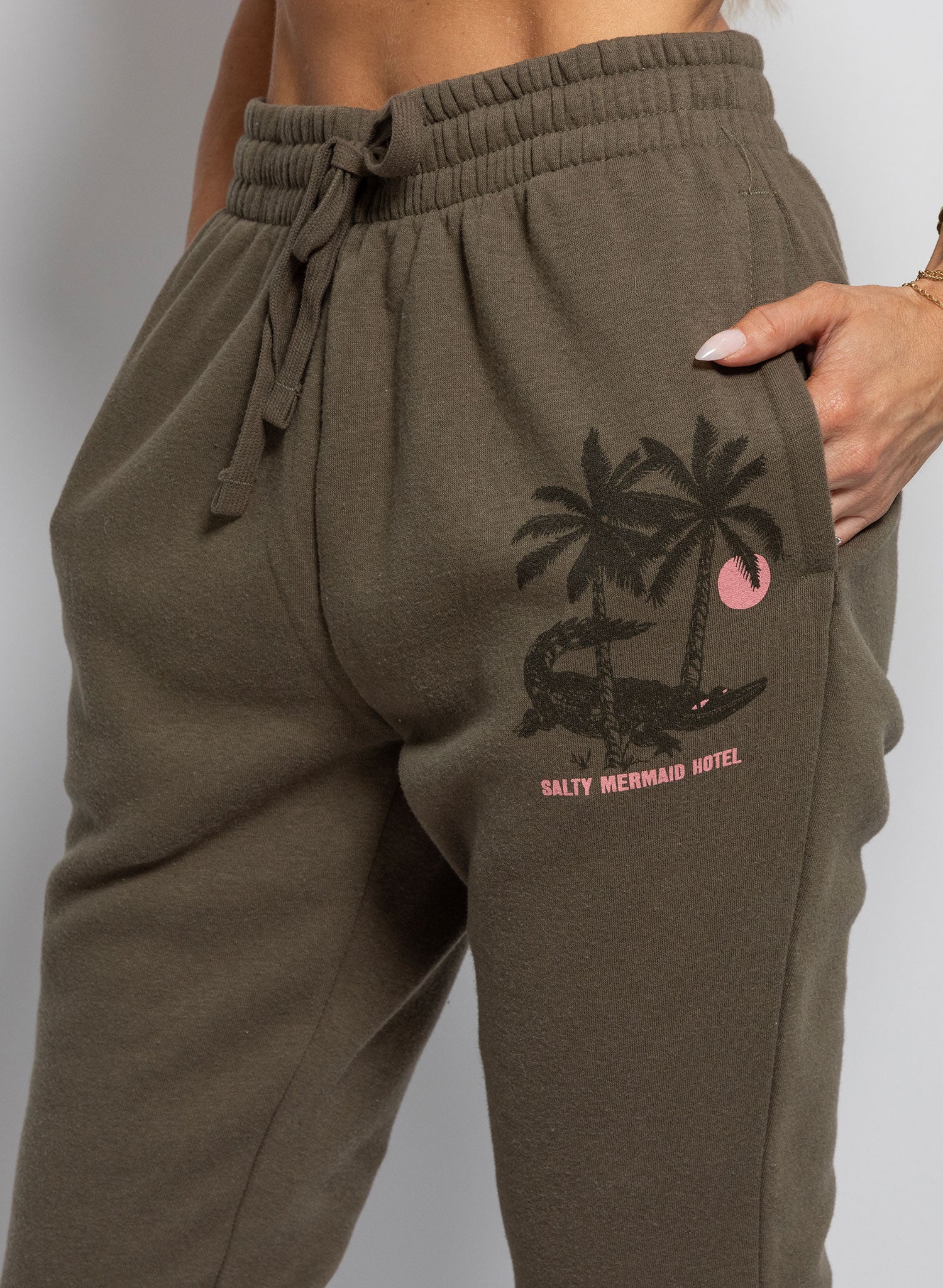 women's dark green jogger with retro aligator print reading "salty mermaid hotel"  matching jogger set.