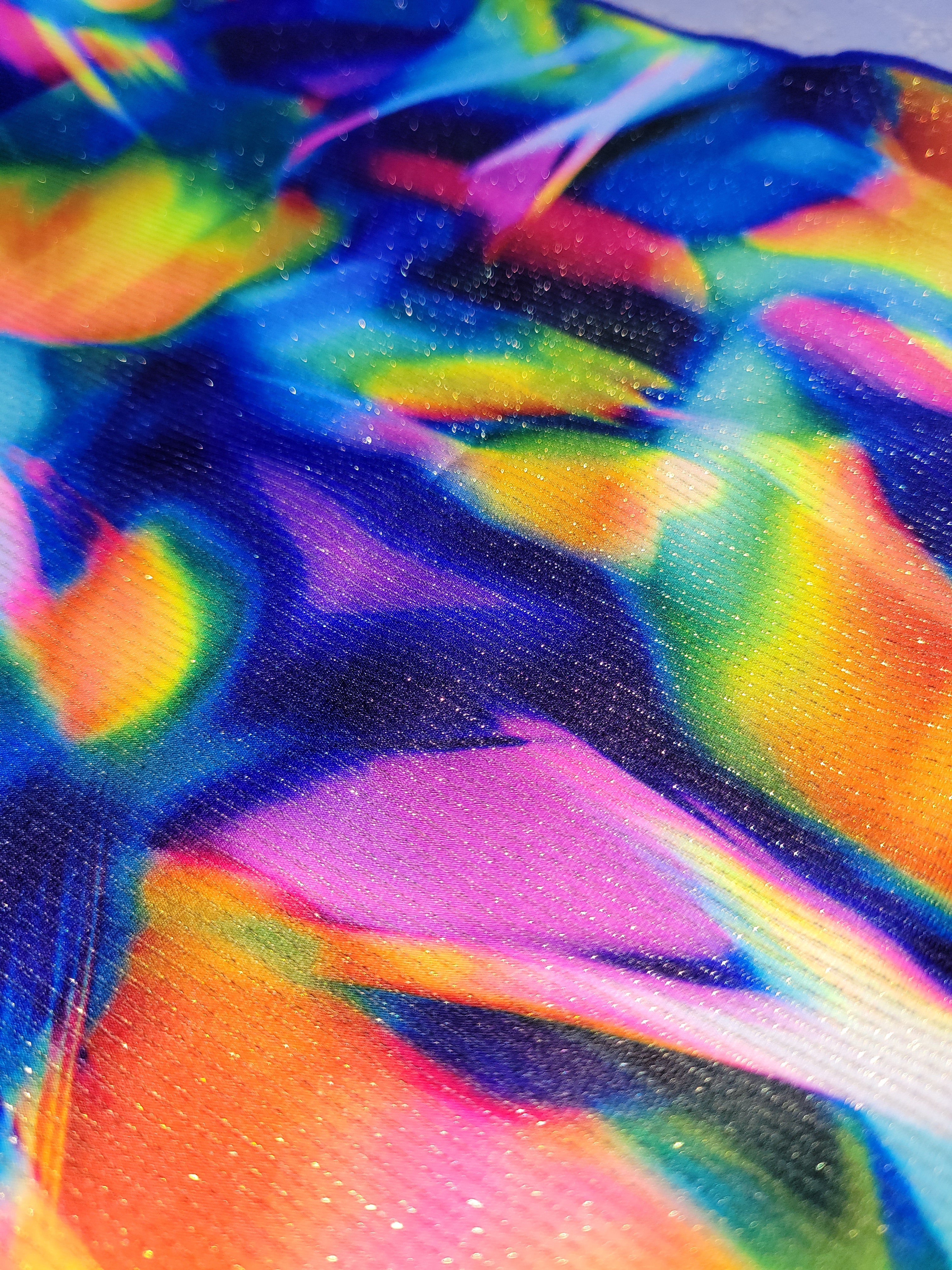Close-up of multicolor fabric for bikini bottom swimsuit by salty mermaid - sunset prism
