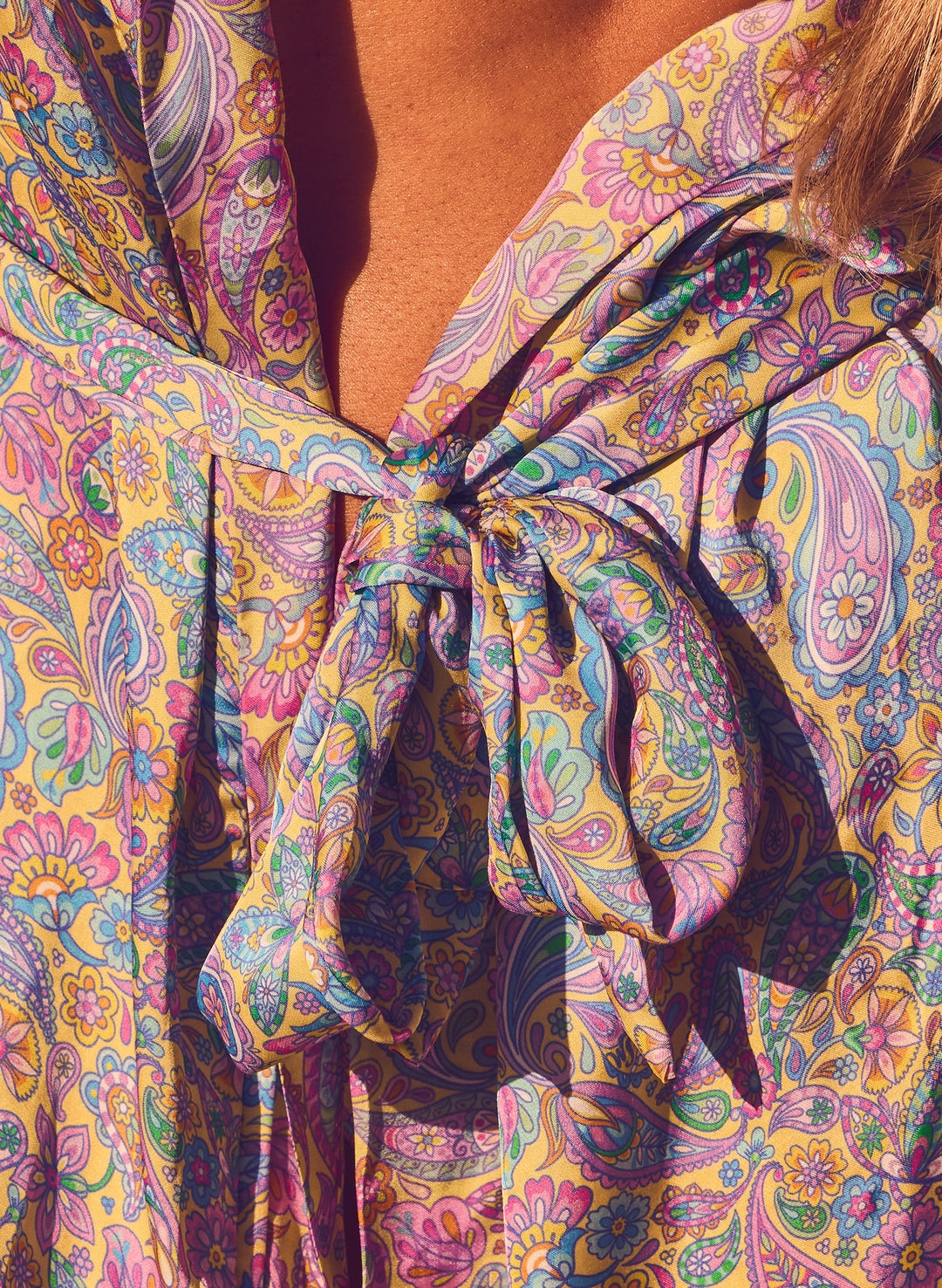 close up of the Sugar Swirl kaftan cover up showcasing the soft textured material and pastel paisley pattern.