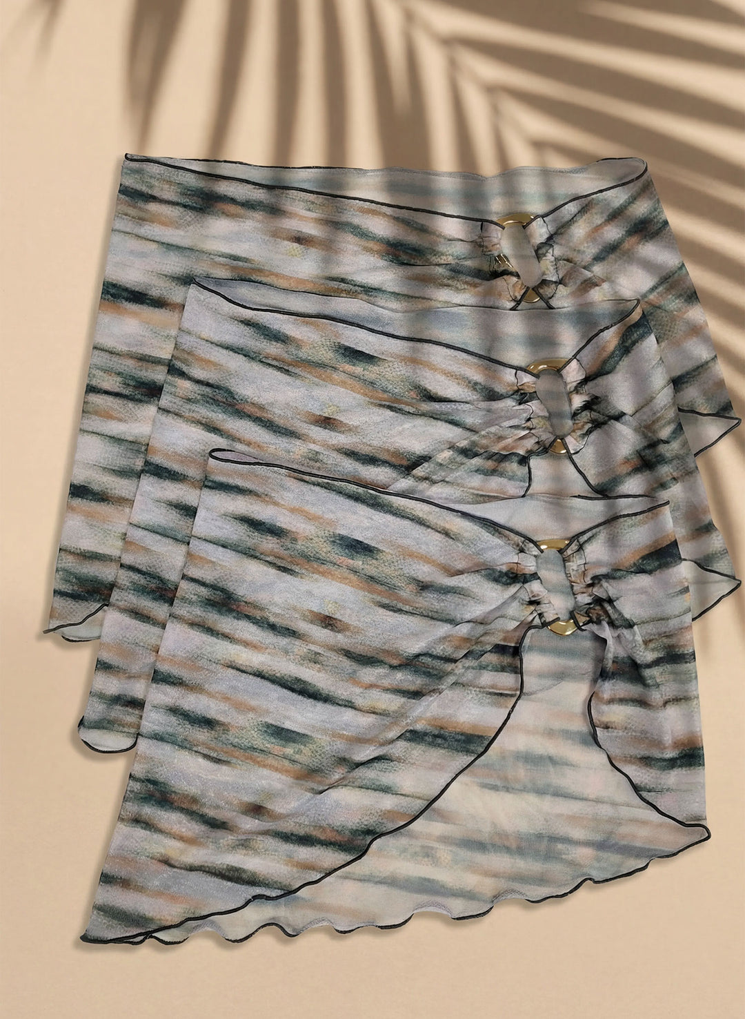 Women’s mesh sarong cover-up flat lay, Coastal Mirage print with gold ring hardware, Salty Mermaid swimwear