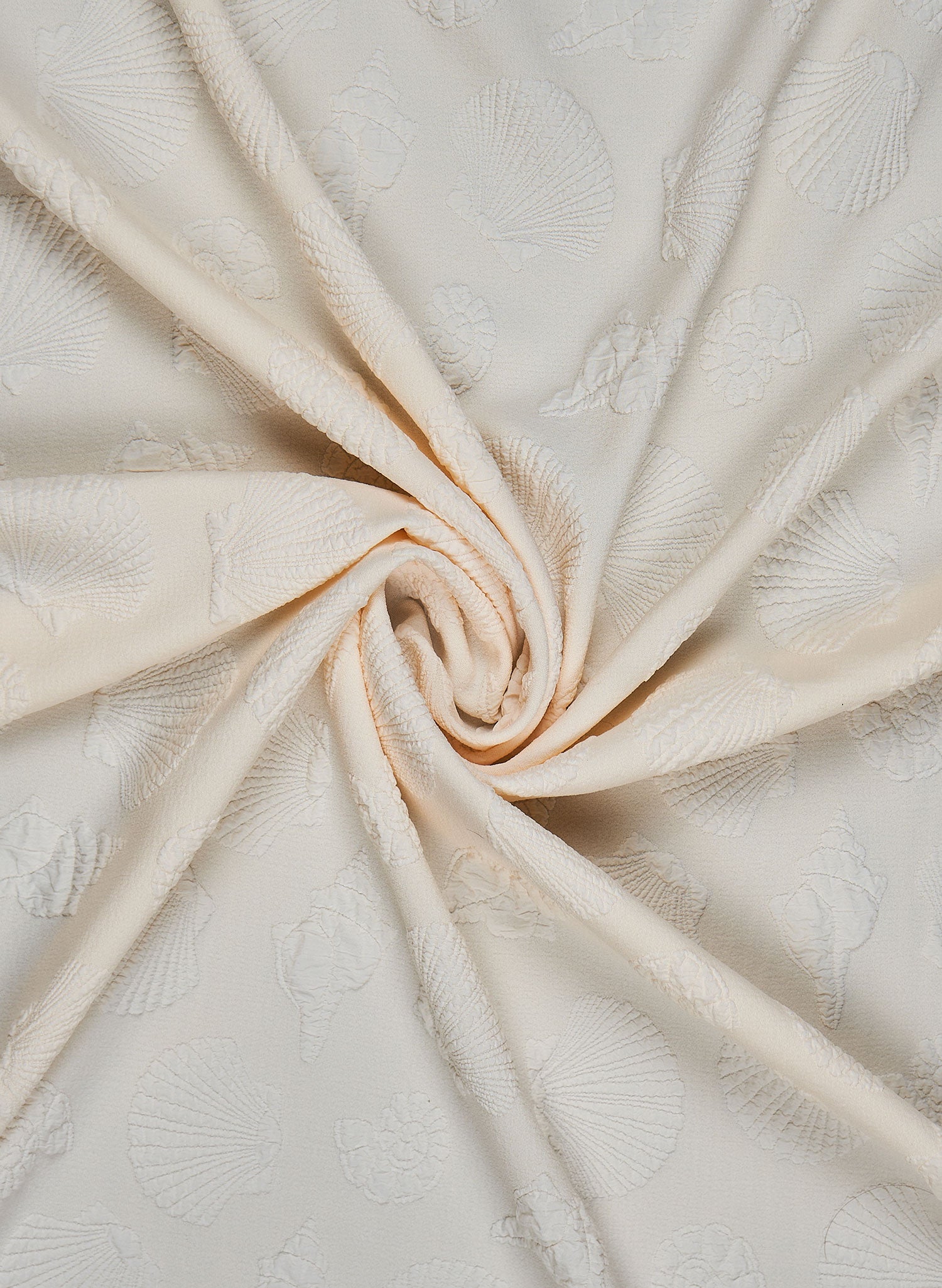 Ivory triangle bikini top with embossed seashell texture and pearl-accented shell charms along the underbust