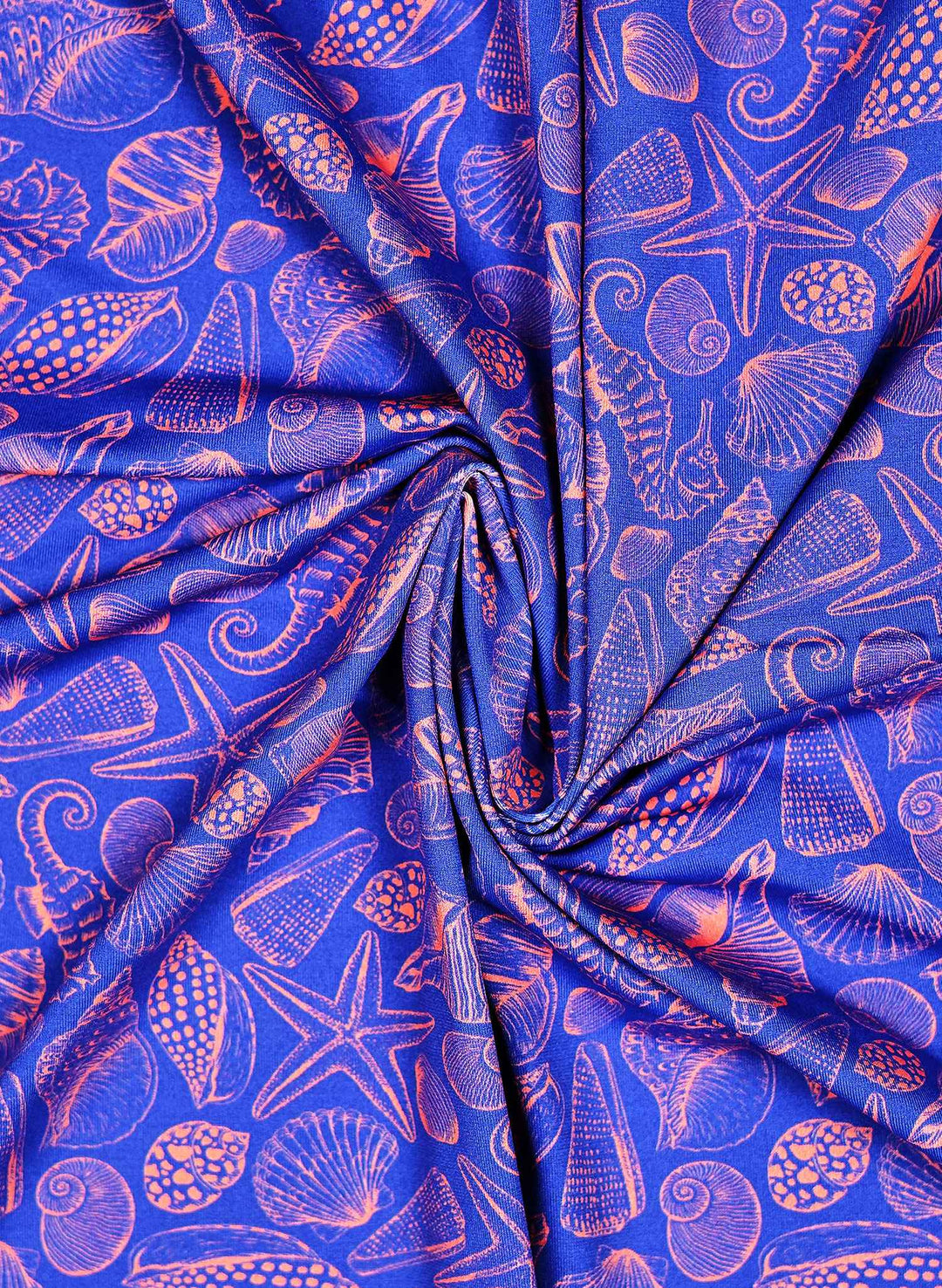 Women's Bathing suit print with Seashell and seahorse print featuring coral pink marine life illustrations on a deep ocean blue background, with starfish, scallops, spiral shells, and seahorses in a coastal beach pattern.