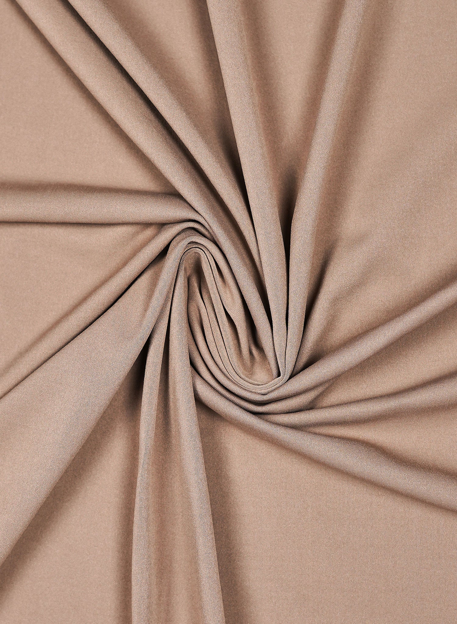 Close-up of beige swimwear fabric with a swirl pattern by salty mermaid.