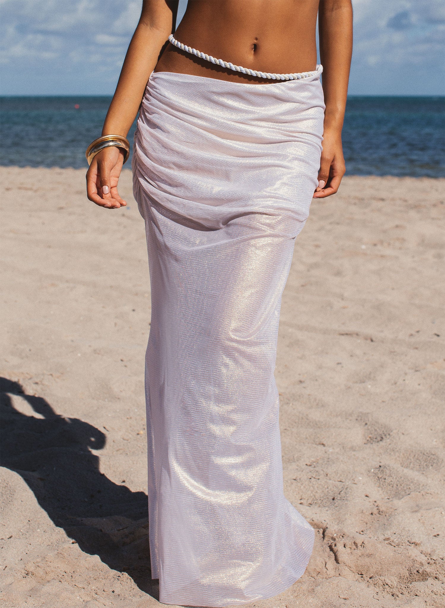 Women’s sheer mesh maxi skirt cover-up with rope belt, shimmering fabric, beach walk detail shot