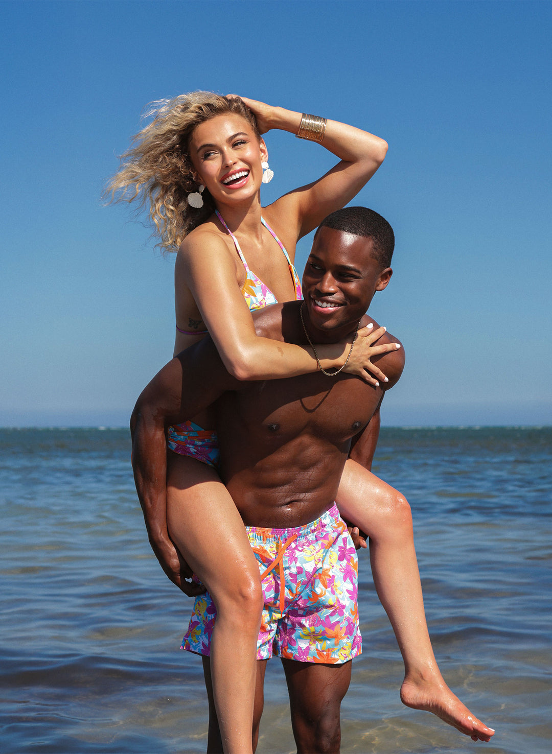 Couples beach photo—Hot Tropic matching swimwear with bikini set and men’s trunks, Salty Mermaid