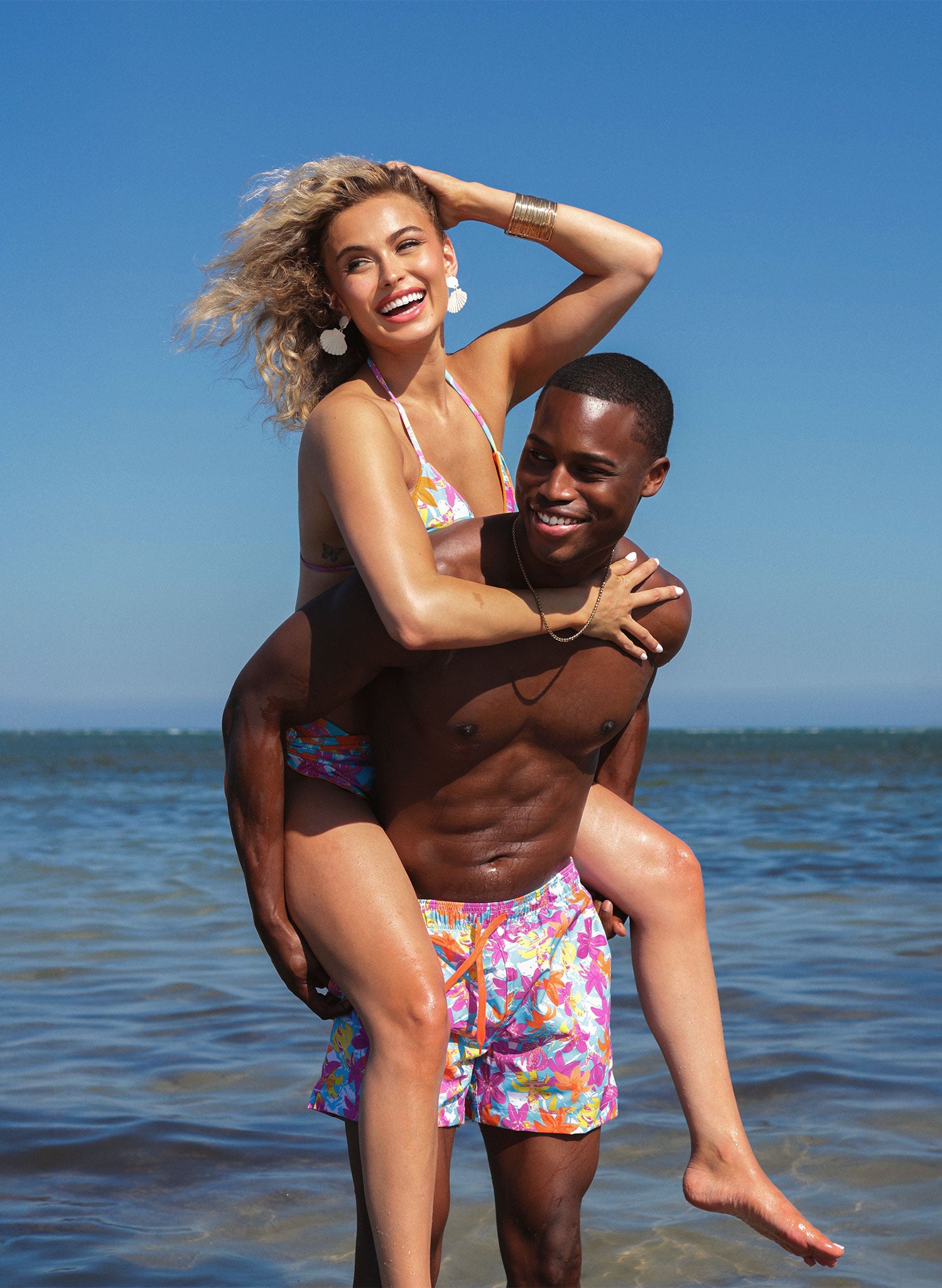 Couples beach photo—Hot Tropic matching swimwear with bikini set and men’s trunks, Salty Mermaid