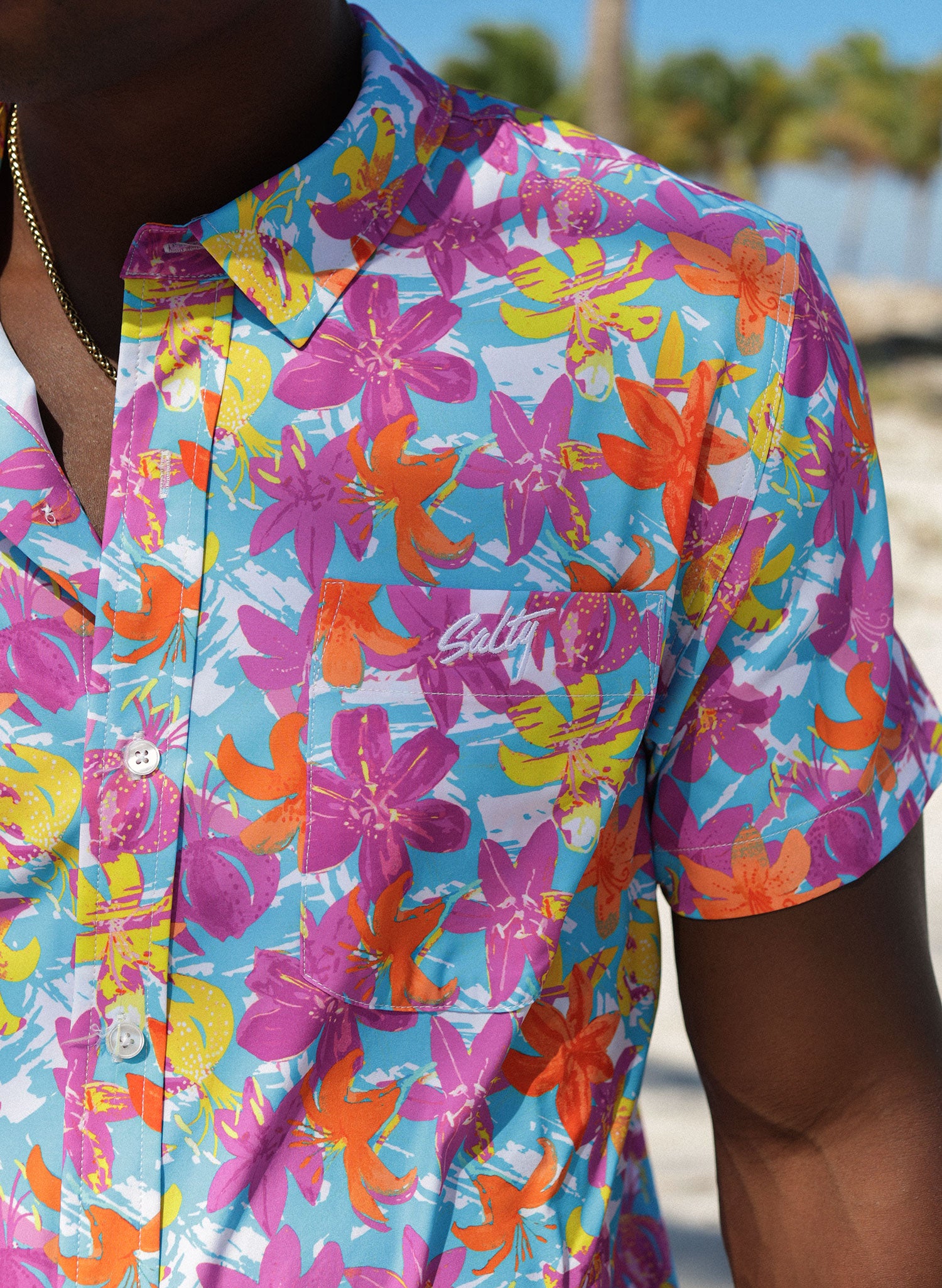 Salty Mermaid men’s Hawaiian style shirt close-up, Hot Tropic retro floral print fabric with chest pocket and Salty Mermaid logo