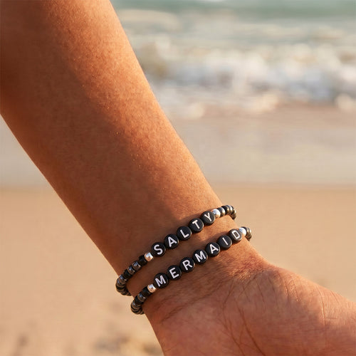 A shahira jewelry Sloan gold belly chain with small, evenly spaced teardrop-shaped bead charms, displayed on a clean white background.