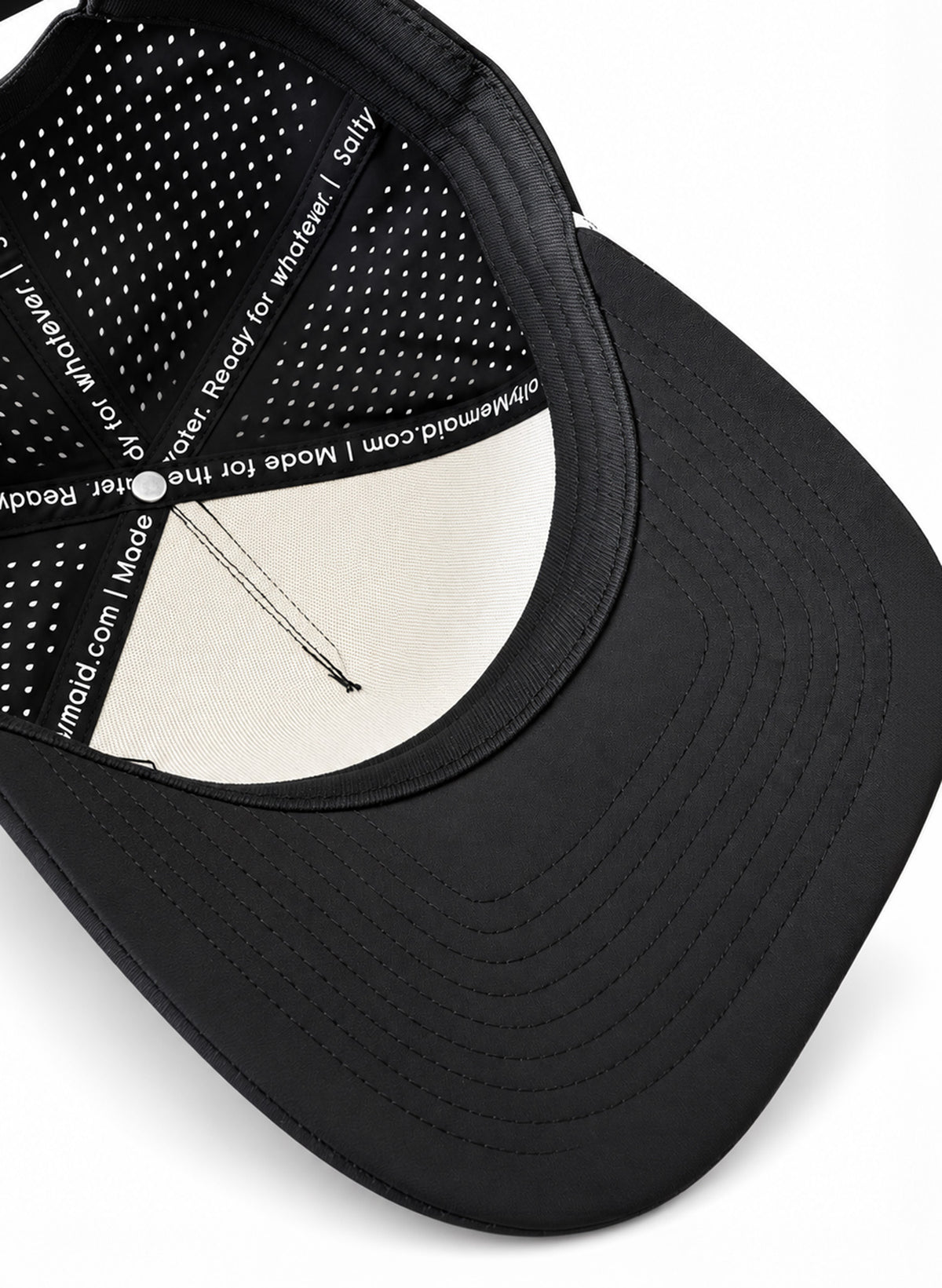Underside of Salty Mermaid black rope hat showing the stitched black brim, sweatband, cream front backing, and printed interior seam tape.
