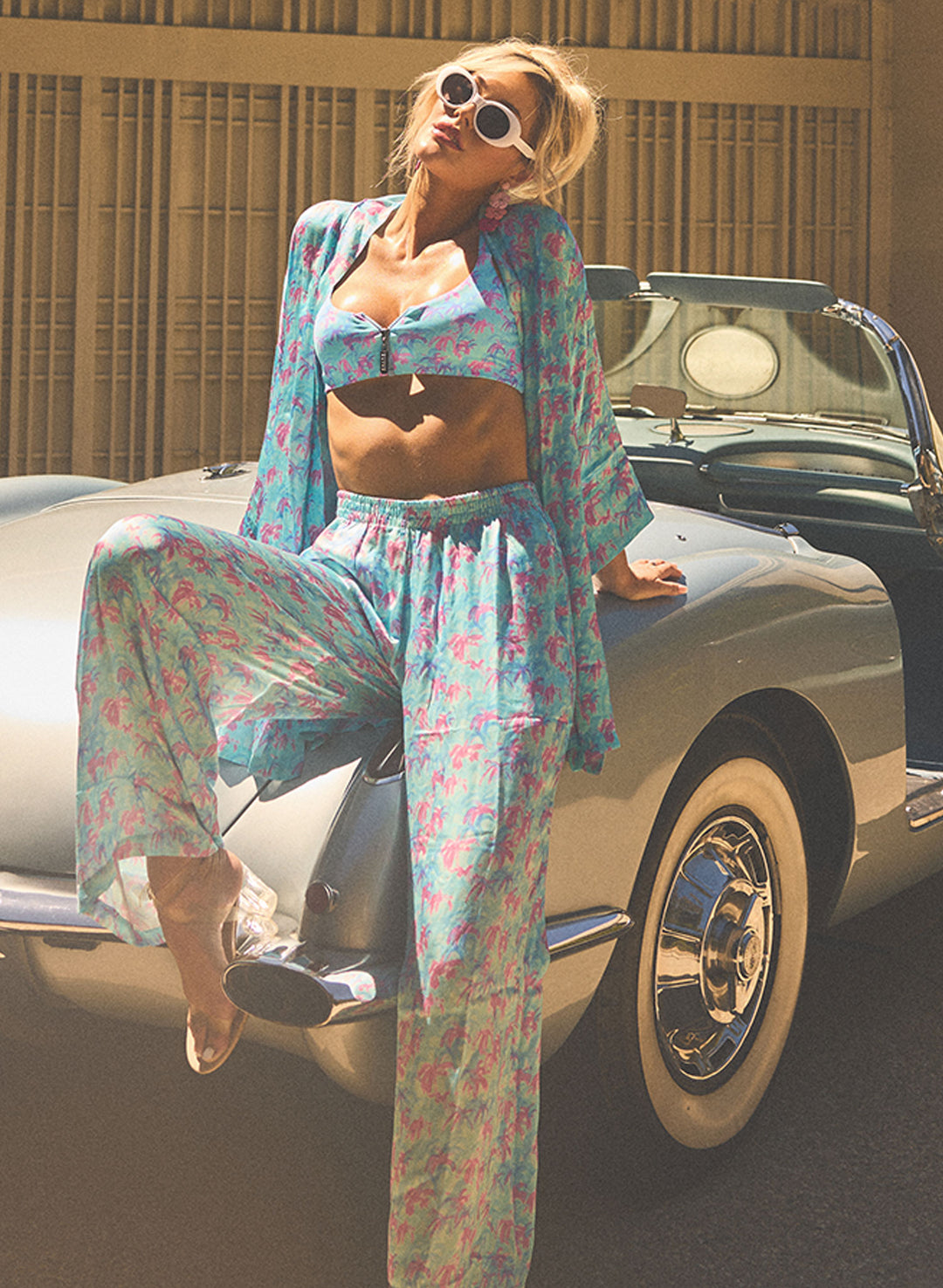 Salty Mermaid Paradise Palms blue and pink floral bikini with matching wide-leg cover-up – palm tree print swimsuit styled with retro vintage car