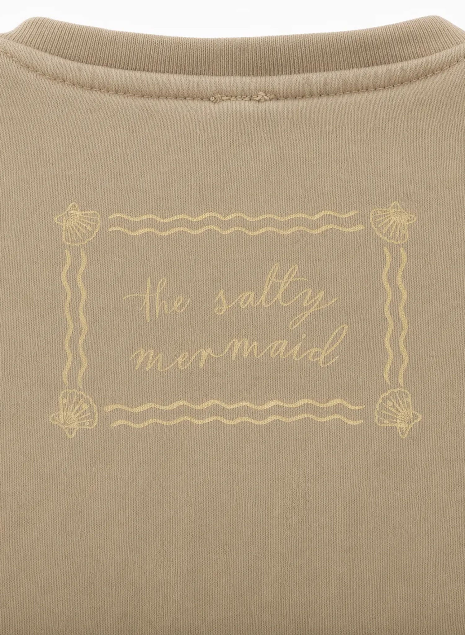 Close-up Salty Mermaid sand crewneck sweatshirt label graphic, shell border print, soft fleece texture
