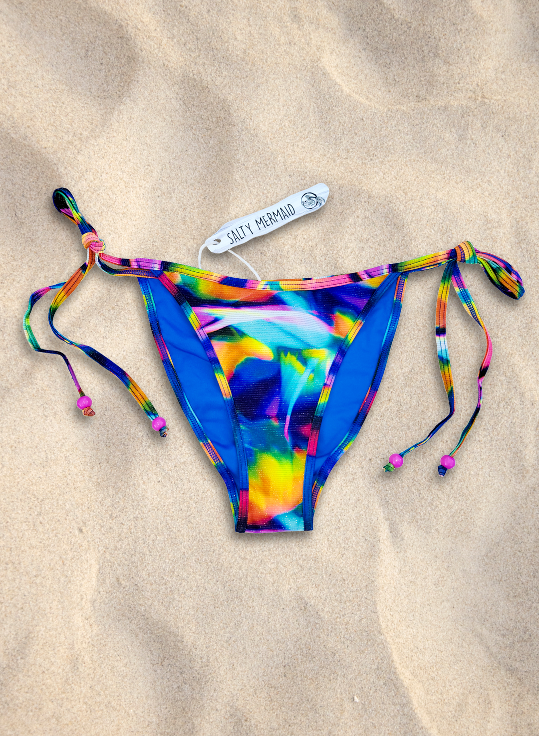 Rainbow abstract print side-tie bikini bottoms with cheeky cut and adjustable ties by Salty Mermaid