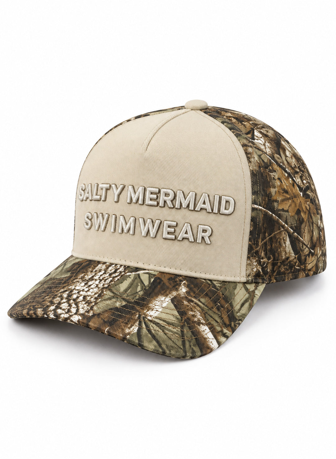 Salty Mermaid Dark Woodland camo snapback hat at a front angle, with a cream embroidered front panel and leafy camo brim and sides on white.
