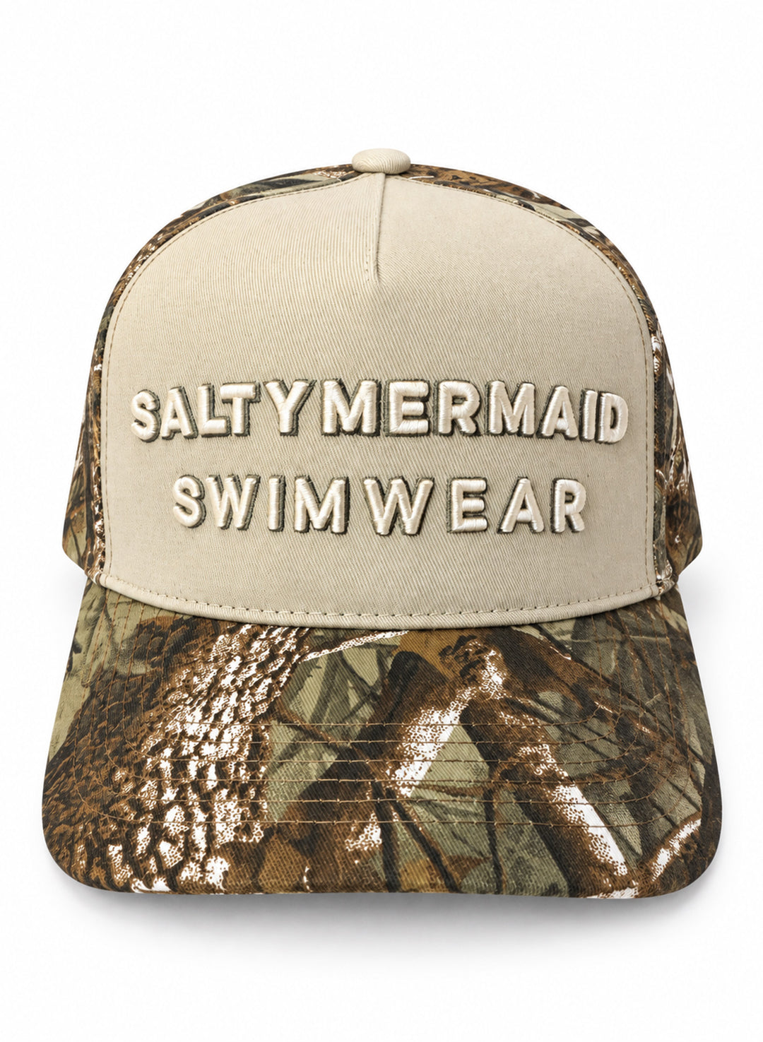 Front view of the Salty Mermaid Dark Woodland camo snapback hat with raised SALTY MERMAID SWIMWEAR embroidery on a cream panel and a camo brim.
