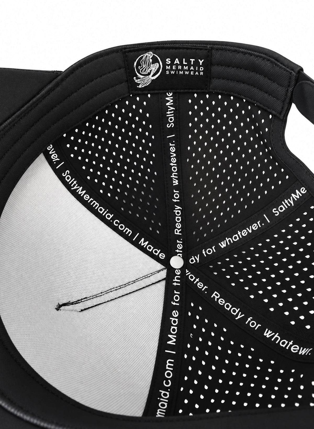 Interior of Salty Mermaid black performance hat showing perforated panels, branded seam tape, black sweatband, and woven mermaid label.
