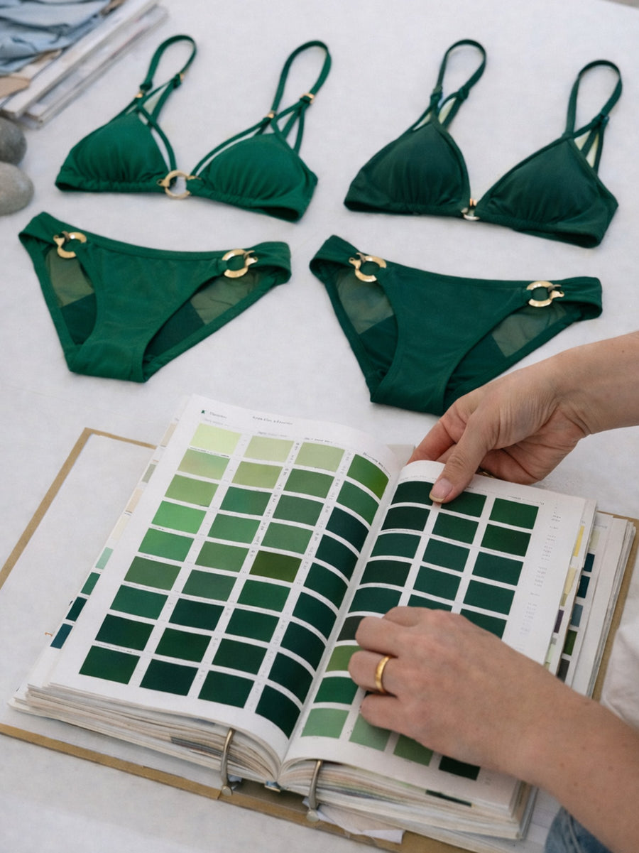 Salty Mermaid sustainable swimwear development process with bikini flat lay, fabric swatches, and eco-conscious design planning
