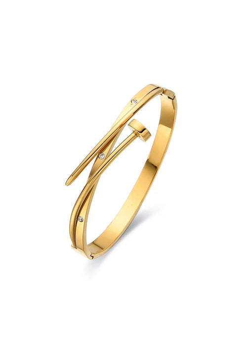 A sahira polished gold kelsie nail bangle bracelet with a modern, open wrap design and small inset clear stones, shown on a clean white background.