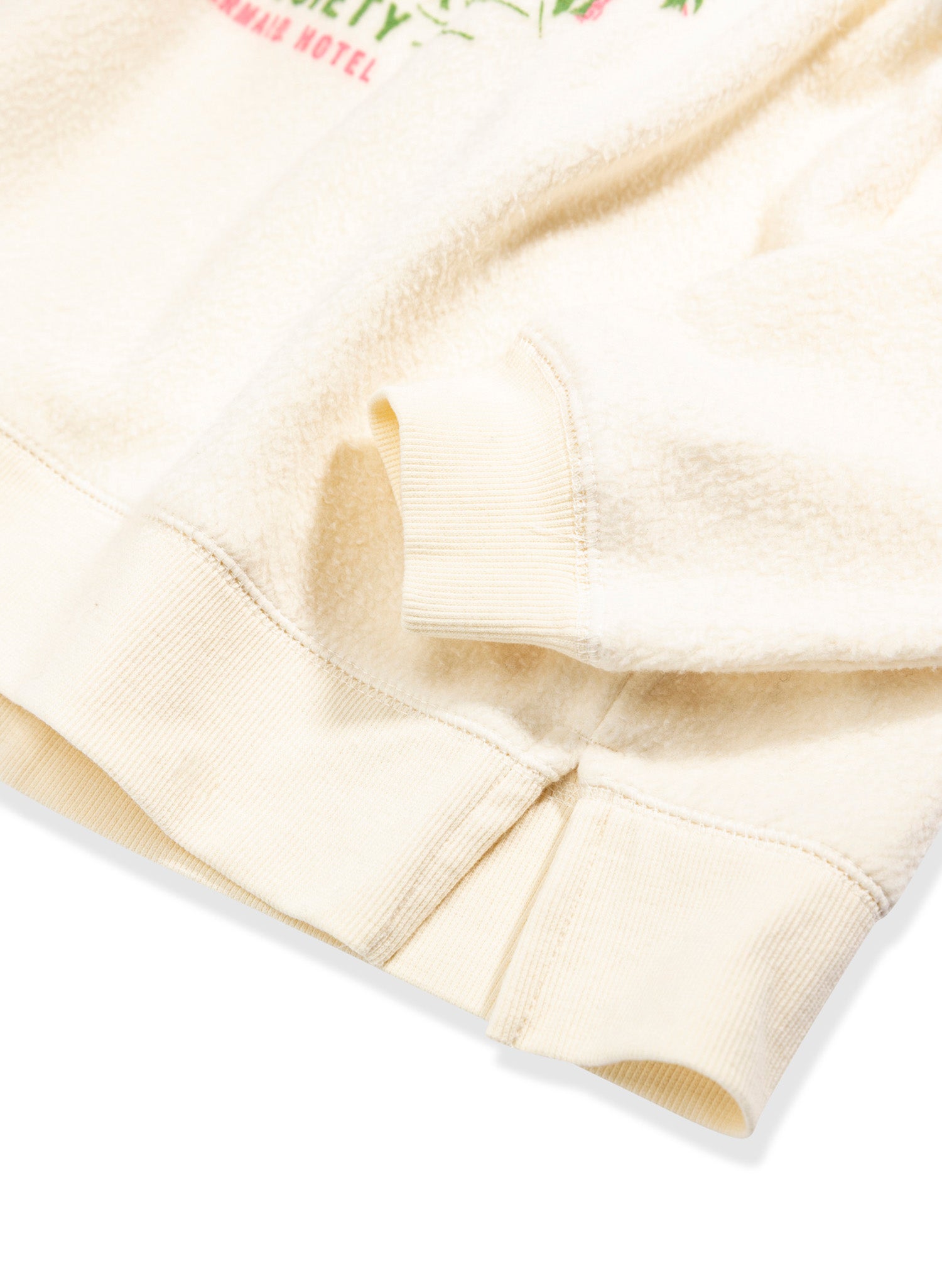Close up of Hotel Collection - Palm Springs- crewneck sleeve featuring open slit sides and cuffed ribbing by Salty Mermaid.